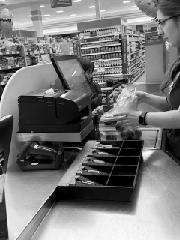 Checking out at the register - <p>Families and Staff enjoyed using math to solve real world problems at Publix!</p>