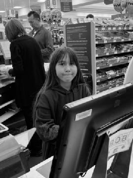 Checking out with their groceries - <p>Families and Staff enjoyed using math to solve real world problems at Publix!</p>